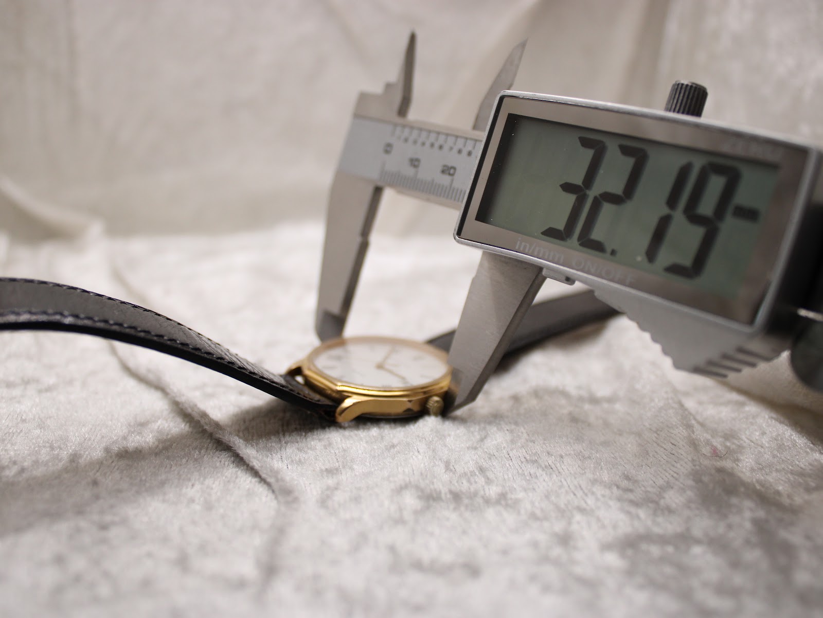 Digital caliper measuring the case diameter of the Certina watch at precisely 32.19mm.