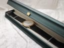 Certina watch with black strap placed inside a green hinged presentation box.