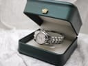 The Tissot PR 200 watch displayed in a dark green presentation box with a gold crown emblem on the lid.