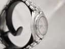 Another side view of the Tissot PR 200 watch on a stand, showing the case profile and integrated bracelet links.