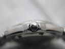 Extreme close-up of the signed "T" logo crown on the Tissot PR 200 watch, indicating its brand heritage.