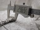 Digital caliper measuring the case diameter of the Tissot PR 200 watch, showing a precise reading of 29.65mm excluding the crown.