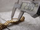 Digital caliper measuring the case diameter of the Raymond Weil Adagio watch, showing a precise reading of 23.89mm.