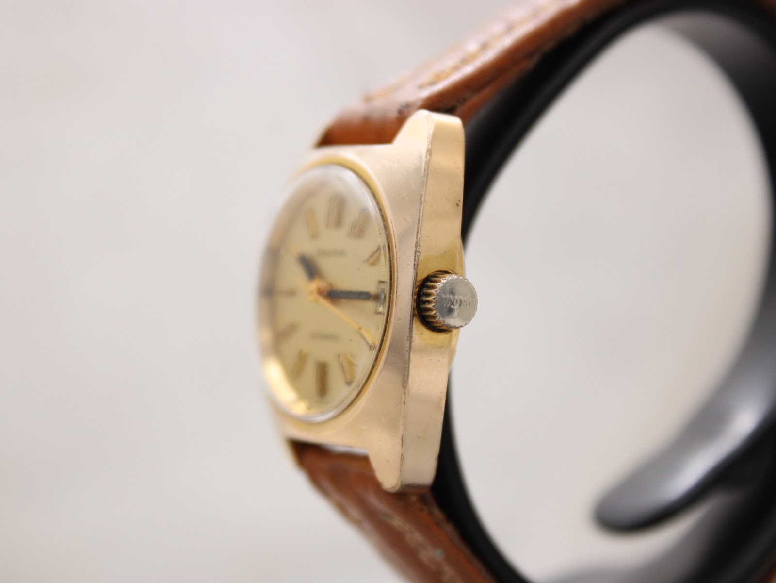 Side view of the Bulova watch, highlighting the gold-plated case and signed Bulova crown.