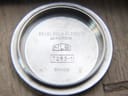 Close-up of the inside of the stainless steel case back, engraved with "BEZEL GOLD PLATED B 20 MICRONS", "MLB", "7263-1", and "SWISS".