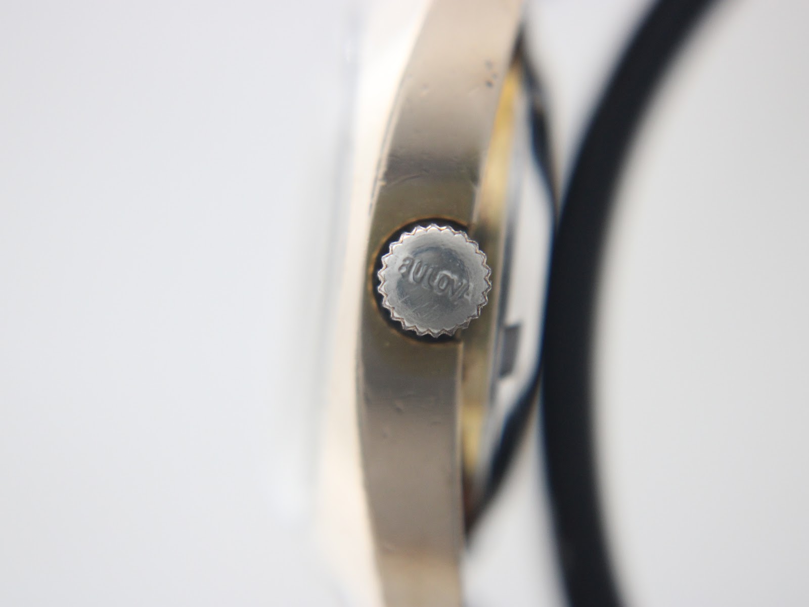 Extreme close-up of the signed Bulova crown, showing the detailed 'BULOVA' engraving.