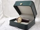 Raymond Weil 683 watch presented in an open dark green presentation box with a crown emblem on the lid.
