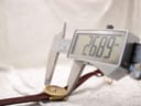 Digital caliper measuring the case length of the watch, displaying a precise measurement of 26.89mm.