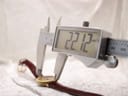 Digital caliper measuring the case width of the watch, displaying a precise measurement of 22.12mm.