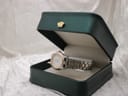 The Tissot PR 50 watch resting inside a dark green presentation box with a gold crown emblem.