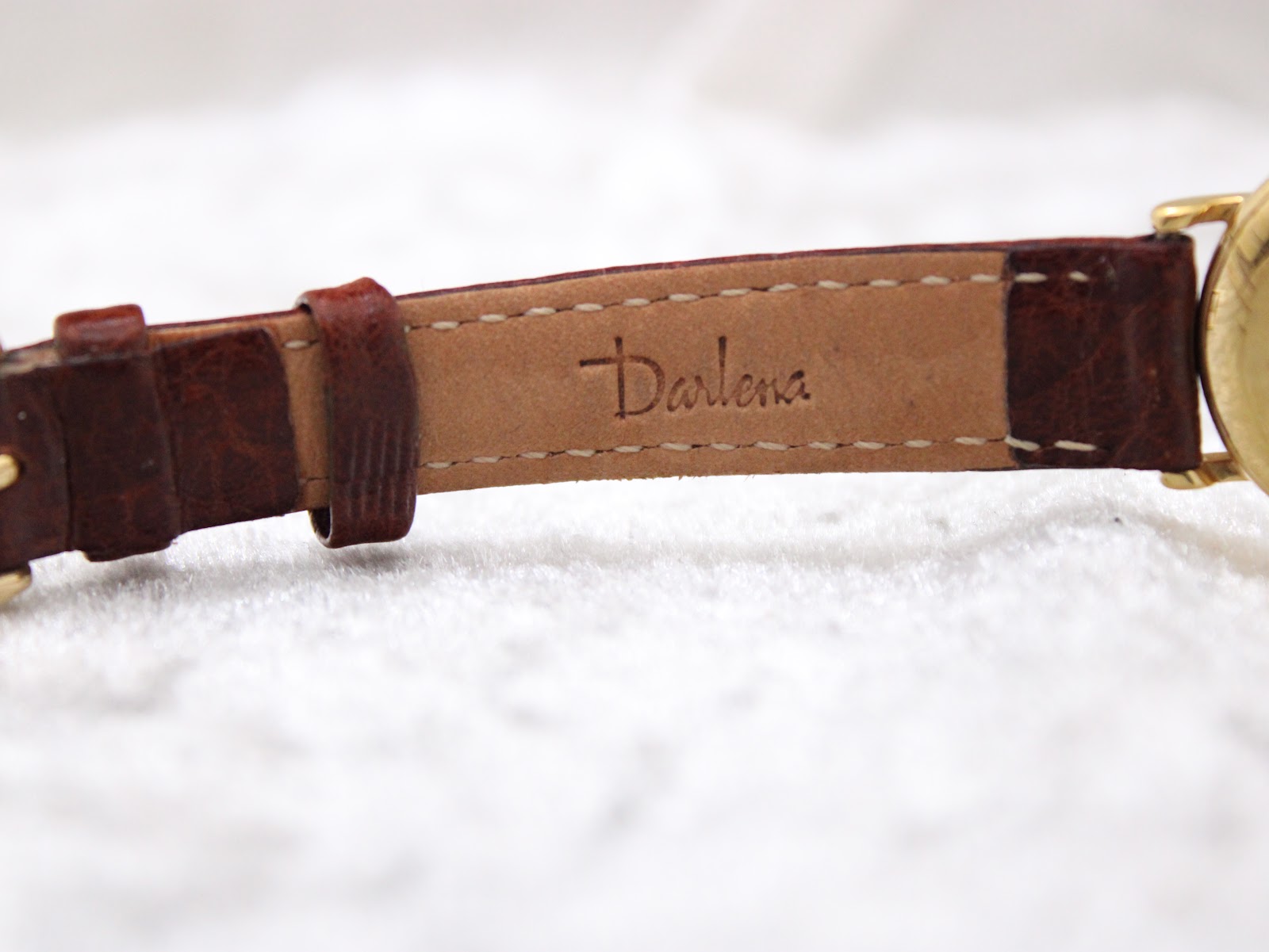 Close-up of the underside of the brown leather strap, clearly showing the "Darlena" brand stamp.
