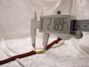 A digital caliper measuring the case diameter of the Raymond Weil 9923, displaying a precise reading of 21.9mm.