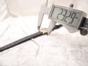 Digital caliper measuring the watch case diameter at 23.29mm, showing the slim profile.