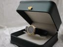 Raymond Weil 5800 watch presented in a dark green display box with a gold crown emblem.