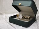 Raymond Weil watch presented inside a dark green display box with a small gold crown detail