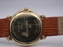 Close-up of the gold-plated case back showing Raymond Weil, 9155, A470119, 18k gold electroplated, and water resistant engravings with wear.