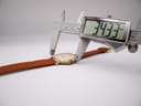 Digital caliper measuring the case diameter of the Raymond Weil watch, displaying 34.33mm.