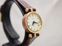 Another angled side view of the Gucci 2000L, highlighting the green and red case stripe and the gold-plated finish.