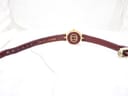 View of the Gucci 2000L from the back, showing the underside of the burgundy leather strap and the gold-toned case back with GG logo.