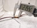 Close-up of a digital caliper measuring the case diameter of the Gucci watch at 21.55 mm.
