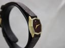 Another side view from a different angle, showing the slim profile of the gold-plated hexagonal case.