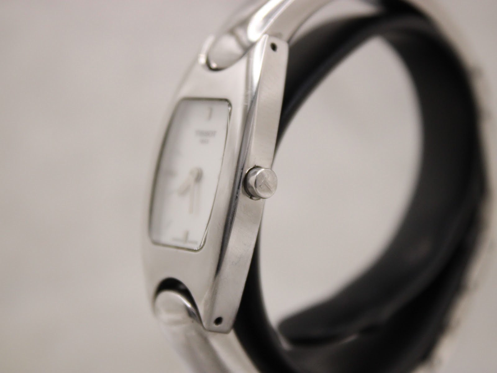 Side view of the Tissot bangle watch showing the polished stainless steel case and original crown.