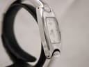 Another side profile view of the Tissot watch, highlighting its elegant, slim design and integrated bracelet.