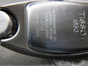 Close-up of the polished stainless steel case back, showing 'Tissot 1853', 'Waterresistant 30M', 'Sapphire Crystal', 'Stainless Steel', 'C845', and serial 'QKR-BC-24751' engravings.