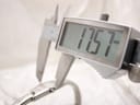 Digital caliper measuring the Tissot watch case, displaying a precise diameter of 17.57 mm.