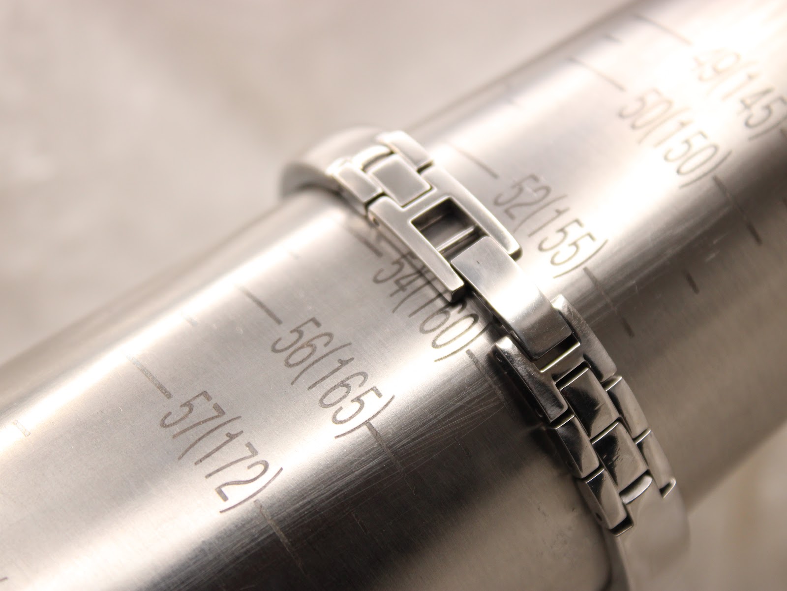 The watch bracelet positioned on a wrist sizing gauge, indicating a wrist fit of approximately 160 mm or 16 cm.