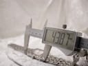 Digital caliper measuring the watch lug-to-lug length at 43.87mm, with the watch resting on a support.