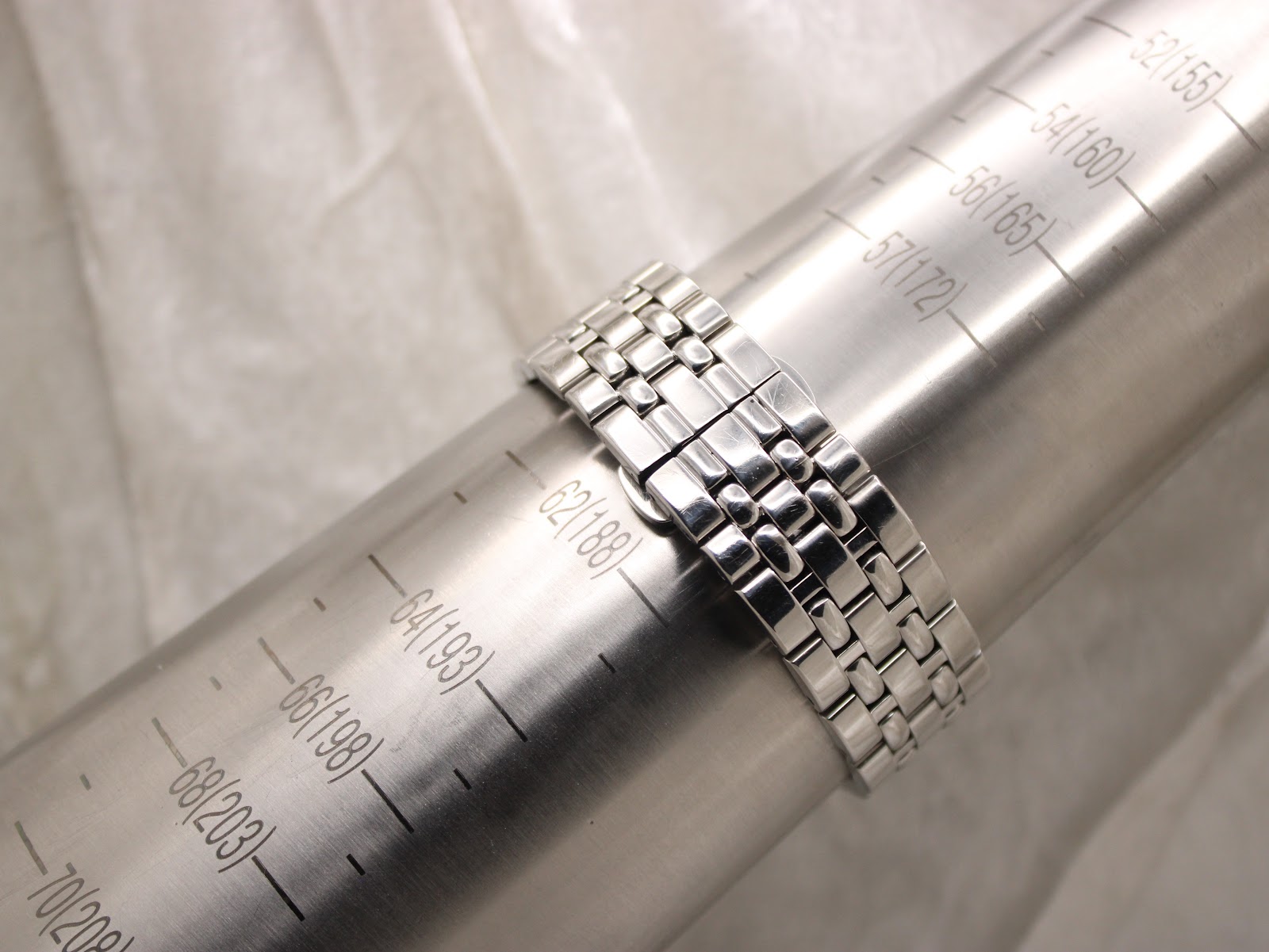 Watch bracelet positioned on a wrist sizing gauge, indicating a current wrist circumference of approximately 188mm or 18.8cm.
