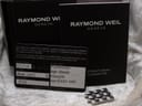 Original Raymond Weil warranty card, instruction booklets, and additional stainless steel bracelet links.
