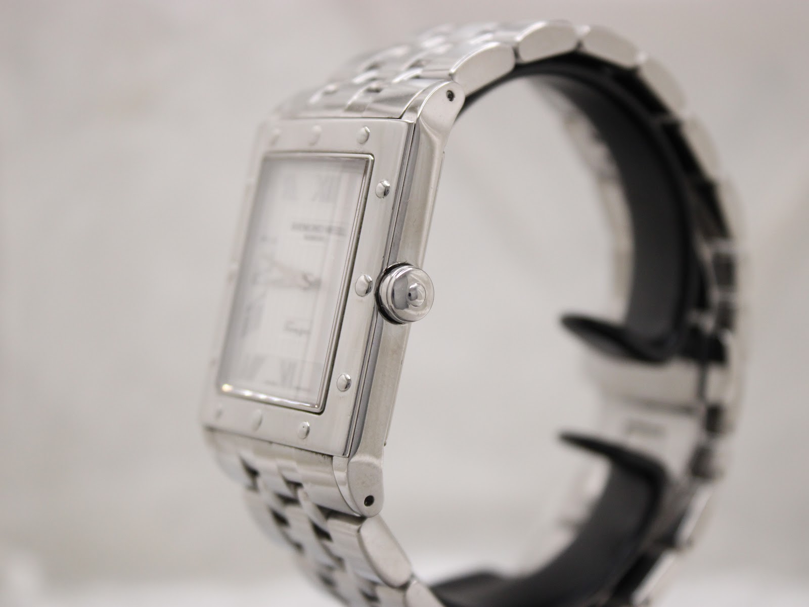 Right side profile of the Raymond Weil Tango watch, showcasing the polished case and simple crown.