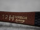 Close-up of the underside of the black leather strap, showing '12', 'HIRSCH', and 'Rainbow' branding in gold lettering.