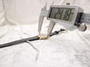 Digital caliper measuring the case diameter of the Raymond Weil watch, displaying a reading of 24.18mm.