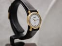 Another angled side view of the Raymond Weil watch, highlighting the elegant design of the case and its slim profile on the stand.