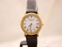 Front view of Raymond Weil Genève watch with gold case, white Roman dial, and brown leather strap.