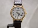 Front view of Raymond Weil 5331 ladies watch with gold-plated case, white chequered dial, and black Roman numerals on a stand.