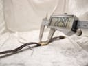 Digital caliper measuring the case diameter of the Raymond Weil watch, displaying 22.90mm.