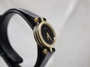 Angled side view of the Gucci 2000L watch, highlighting the minimalist black dial and the tiered gold case design.