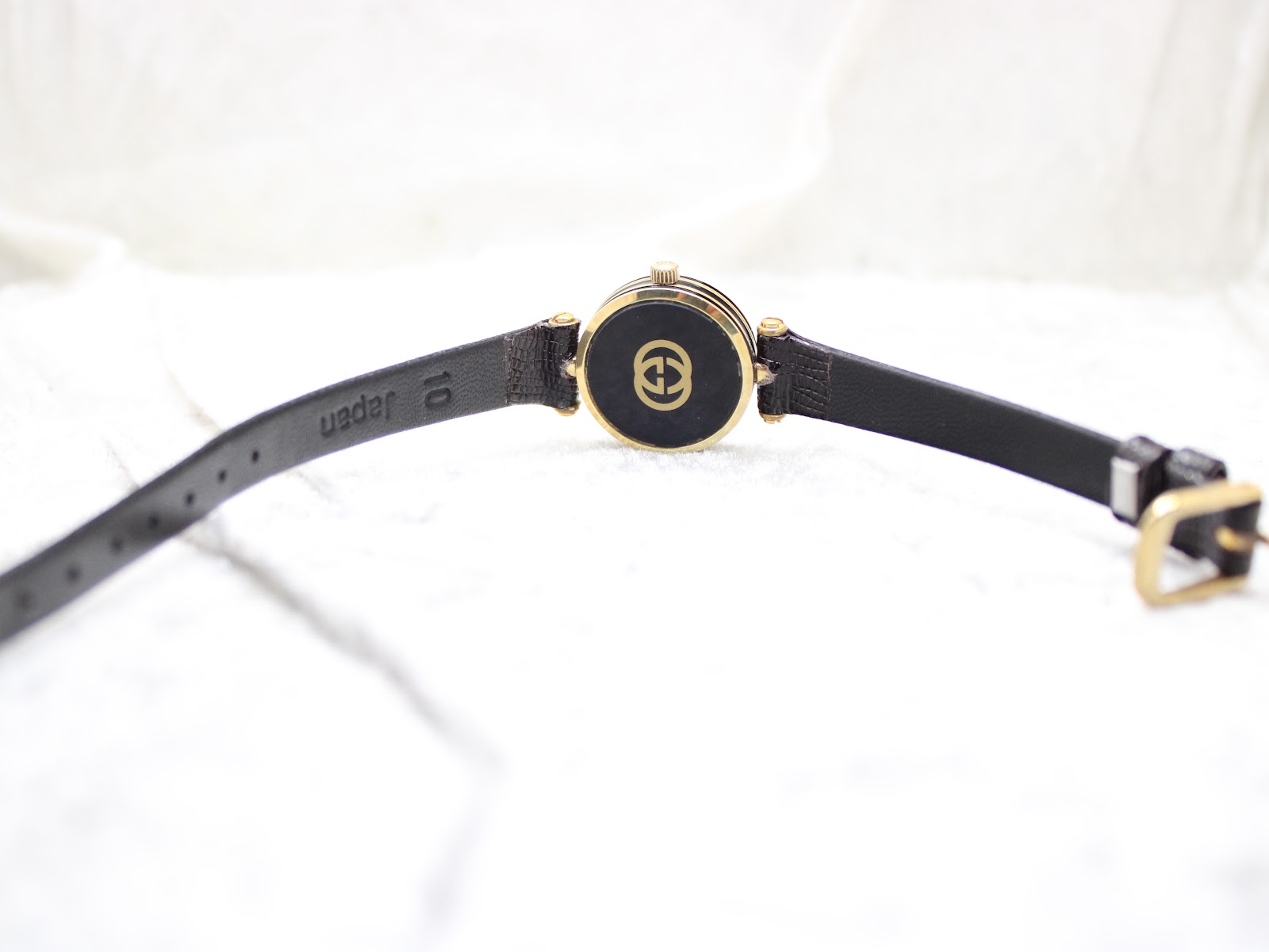 Rear view of the watch and strap, showing the black leather strap's textured finish and a 'japan 10' mark, indicating lug width.