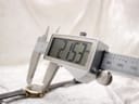 A digital caliper measuring the watch case diameter, displaying a precise reading of 21.53mm on the screen.