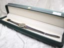 Overhead view of the Gucci 2000L watch resting inside a dark green presentation box with a cream-coloured interior.