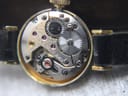 Macro shot of the 17-jewel Swiss manual wind mechanical movement, revealing gears, ruby jewels, and the Tissot calibre marking.