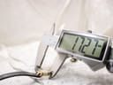 A digital caliper measuring the watch case, displaying a precise diameter of 17.27mm.