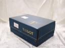 Exterior view of the vintage blue Tissot presentation box, showing the gold 'Tissot' branding and a price sticker.