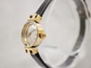 Oblique view of the Tissot watch from the right, highlighting the signed crown and the gold-plated case.