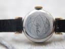 Close-up of the watch's stainless steel case back, engraved with a geometric pattern and "Ayphir" in script.