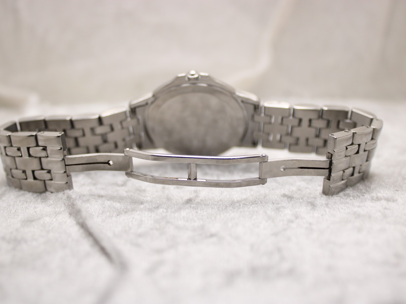 View of the unfolded deployment clasp of the stainless steel bracelet, showing its mechanism.